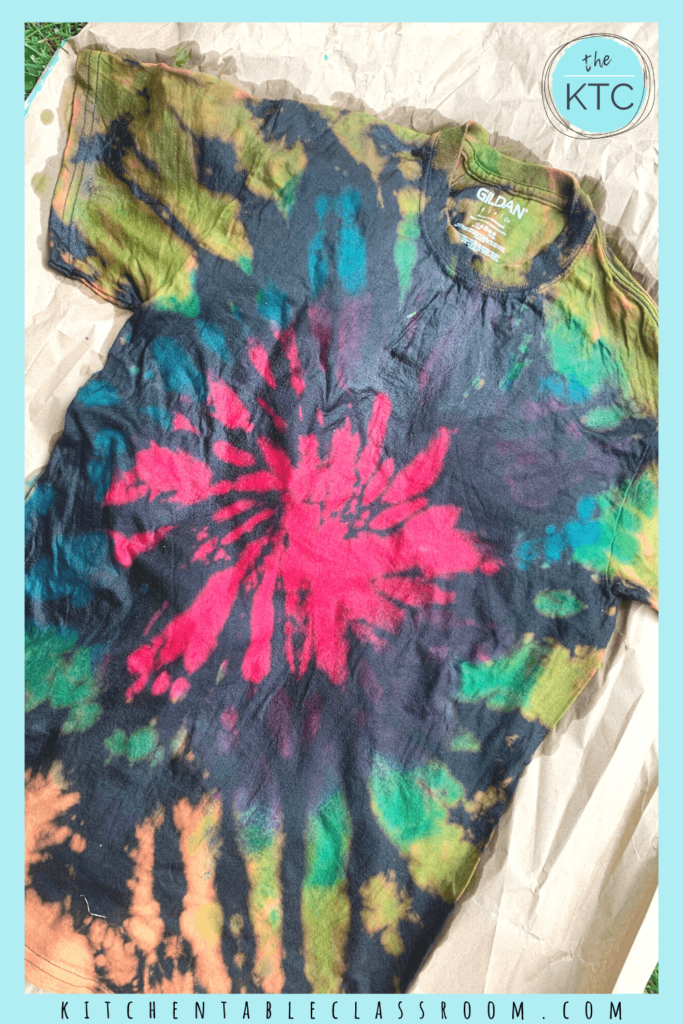 Reverse tie dying soaks previously bleached areas of a dark fabric with colored dye resulting in a bright color tie dye design on a black background.