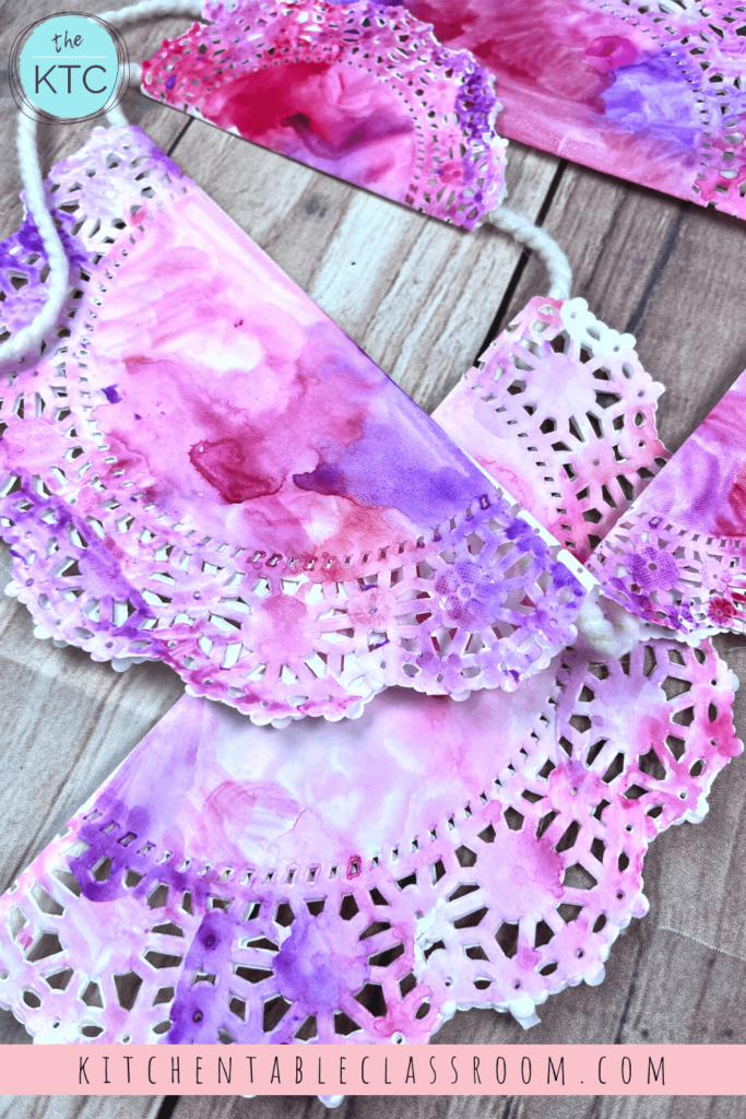 Colorful painted doilies become a DIY paper bunting.