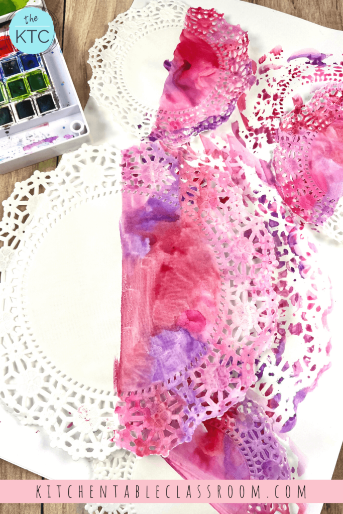 Watercolor paints add a splash of color to these doilies before they become part of a lacy doily bunting.