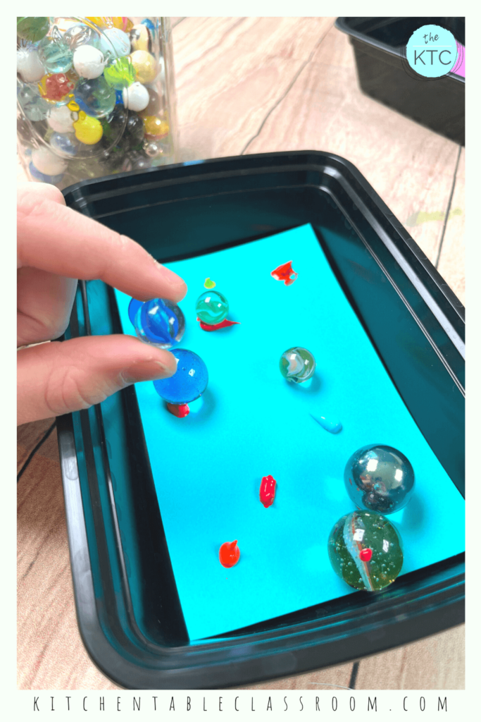 Painting with marbles is a fun process art activity for any age! Use those large motor skills to shake, bounce, and roll!