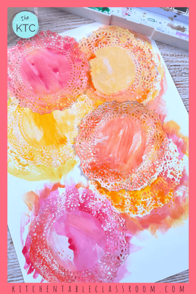 To make paper doily flowers you'll need doilies, watercolor paints, tape, and pipe cleaners!